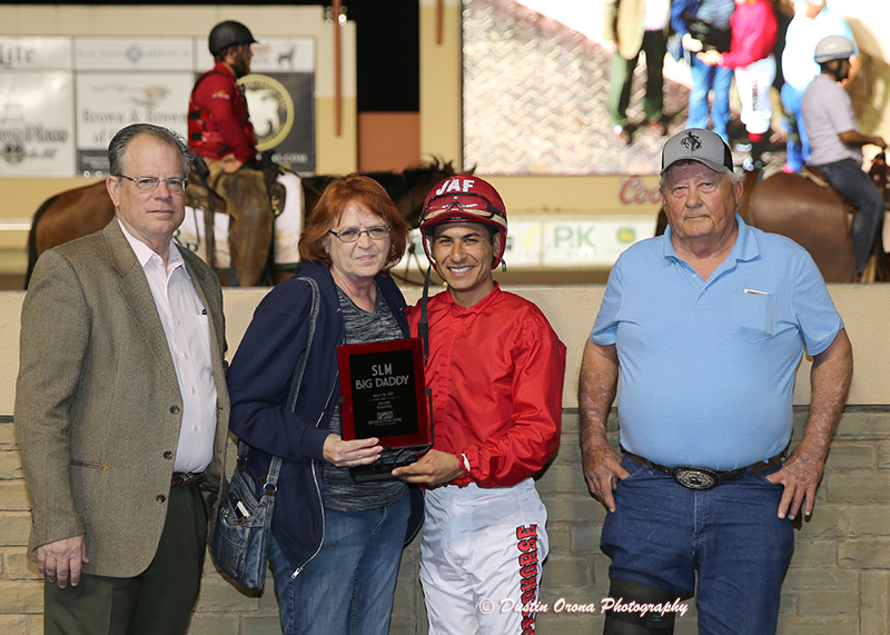 The Winning owner Terry McLean and jockey James Flores accept the SLM Big Daddy Stakes trophy as trainer Gerry McLean looks on Saturday night at Remington Park.  • Dustin Orona Photography